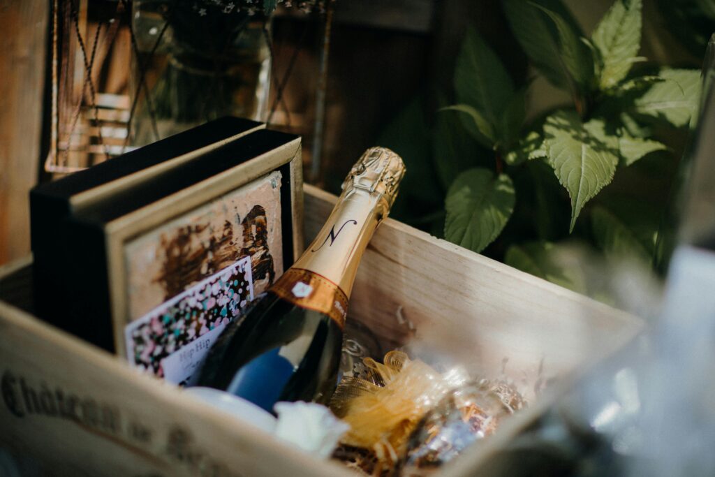 Elegant close-up of champagne bottle in a stylish wooden gift box with decorative elements.